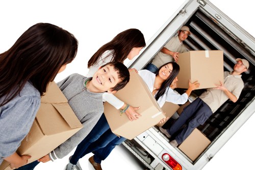 Movers loading household items in a Maida Vale street