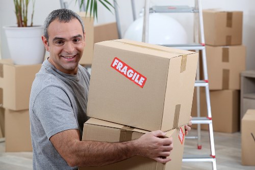 Removal team handling boxes during a house move in Maida Vale