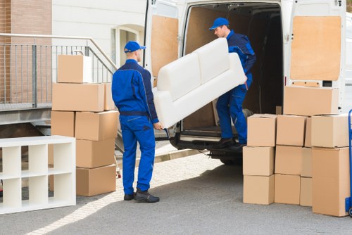 Furniture being carefully loaded into a moving van