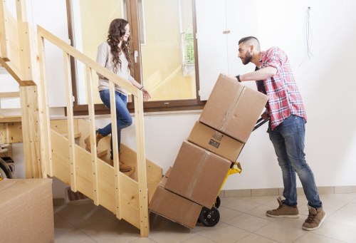 Removal team handling bulky items in a Maida Vale property