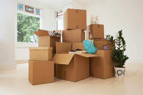 Professional movers carrying furniture through a Maida Vale property