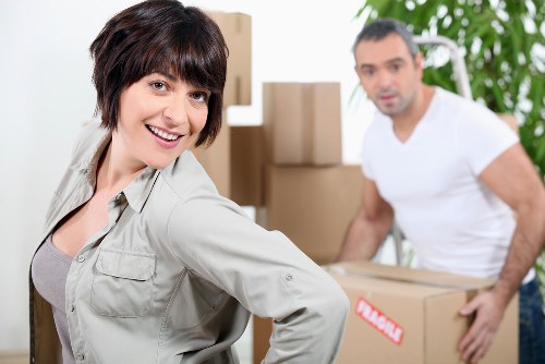 Moving team loading boxes and furniture into a van