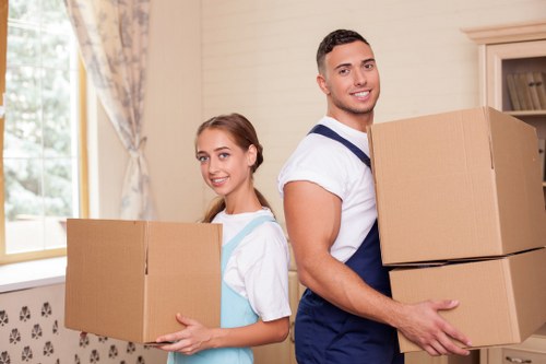 Professional movers handling boxes and furniture in a Maida Vale flat
