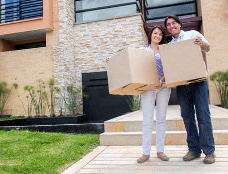 Movers handling office equipment carefully in a local building